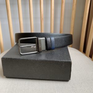 This reversible belt features the signature Saffiano leather belt on one side